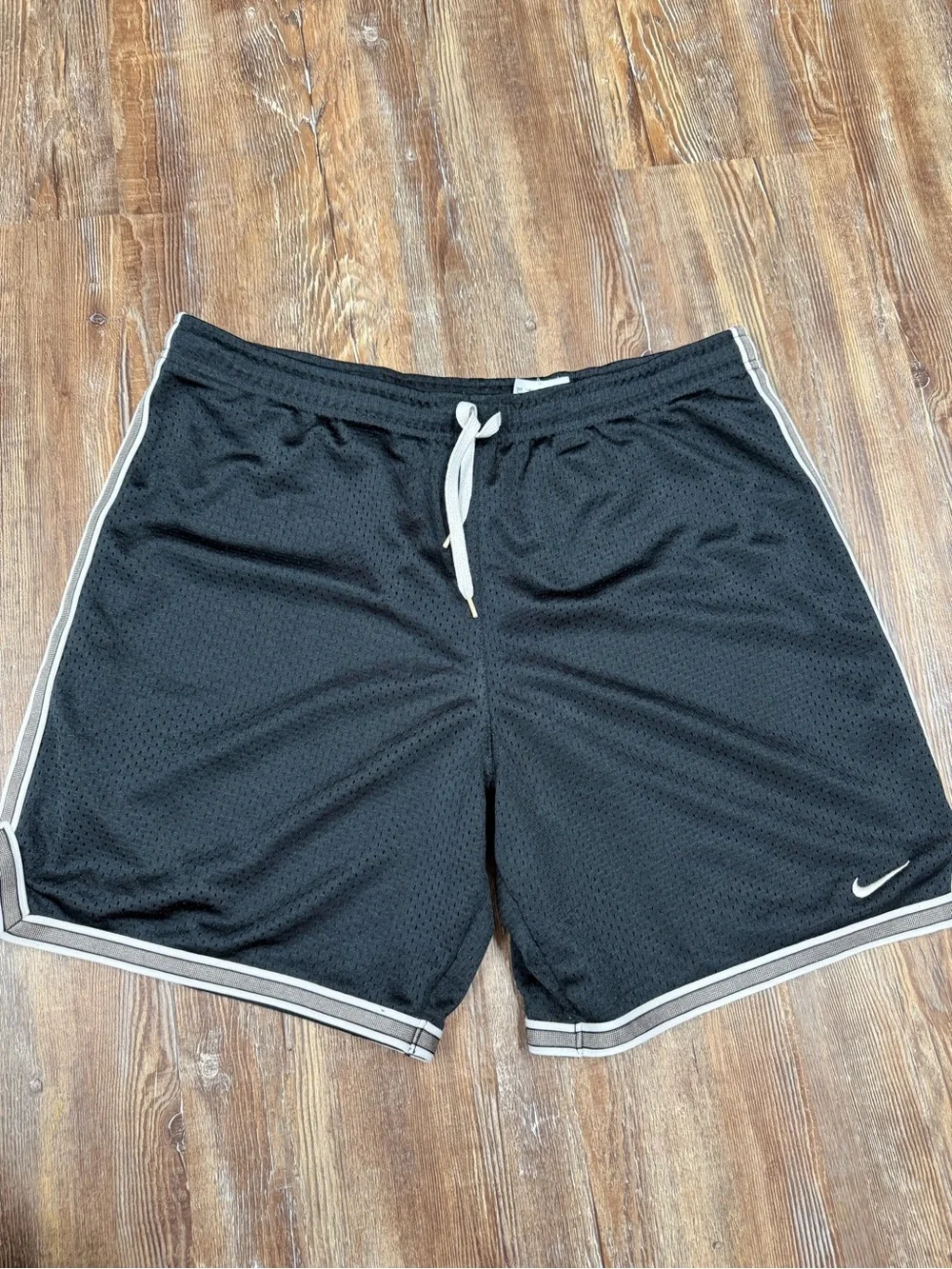 Vintage y2k Nike black shorts with white stripes on sides and hem, size S